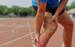 an athlete holding an injured leg