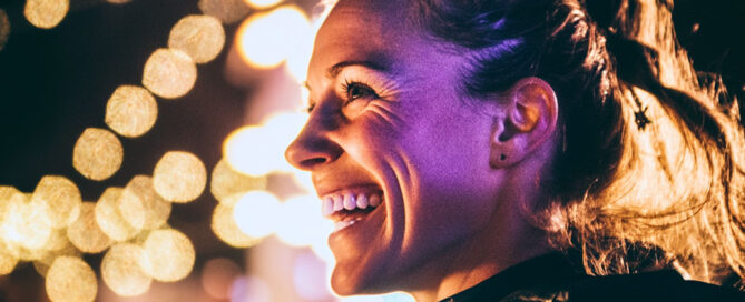 a woman smiling at a New Year's Eve celebration